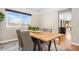 Dining room with a long wooden table and gray upholstered chairs at 6858 Johnson St, Arvada, CO 80004