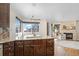 Kitchen features granite countertops, dark wood cabinets, and a breakfast bar at 6858 Johnson St, Arvada, CO 80004