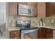 Modern kitchen with stainless steel appliances and granite countertops at 6858 Johnson St, Arvada, CO 80004