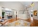 Bright living room with hardwood floors, high ceilings, and a view of the dining area at 6858 Johnson St, Arvada, CO 80004