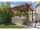 Outdoor kitchen with granite countertop and pergola at 6858 Johnson St, Arvada, CO 80004