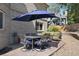 Outdoor patio furniture under a blue umbrella at 6858 Johnson St, Arvada, CO 80004