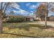 Charming brick home with a well-manicured lawn, showcasing its classic design under a bright sky at 2675 N Saint Paul St, Denver, CO 80205