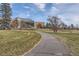 Path with grassy lawns and mature trees, leading to the structure at 2675 N Saint Paul St, Denver, CO 80205