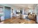 Bright living room featuring hardwood floors, neutral decor, and a seamless flow to the dining area at 2675 N Saint Paul St, Denver, CO 80205