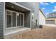 Backyard patio with sliding glass doors and low-maintenance landscaping at 5319 Warrior St, Frederick, CO 80504