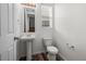 Powder room features modern fixtures, pedestal sink, and wood-look flooring at 5319 Warrior St, Frederick, CO 80504