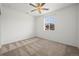 Bright bedroom with neutral carpet, ceiling fan, and a window at 5319 Warrior St, Frederick, CO 80504