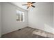 Cozy bedroom with neutral carpet, ceiling fan, and bright window at 5319 Warrior St, Frederick, CO 80504
