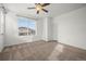 Large bedroom with neutral carpet, bright window, and ceiling fan at 5319 Warrior St, Frederick, CO 80504