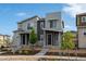 Modern home with stone accents, complemented by a landscaped front yard and a clear blue sky at 5319 Warrior St, Frederick, CO 80504