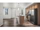 Bright, open kitchen with a central island, stainless steel appliances, and stylish pendant lighting at 5319 Warrior St, Frederick, CO 80504