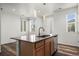 Contemporary kitchen featuring an island with seating, stainless steel appliances, and ample natural light at 5319 Warrior St, Frederick, CO 80504