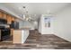 Open-concept kitchen with stainless steel appliances, an island, wood cabinets, and a seamless connection to the living area at 5319 Warrior St, Frederick, CO 80504
