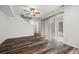 Bright living room area with sliding doors to back patio, ceiling fan and seamless flow to the dining area at 5319 Warrior St, Frederick, CO 80504