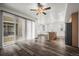 Bright living area seamlessly integrating with a modern kitchen, featuring large windows and stylish wood floors at 5319 Warrior St, Frederick, CO 80504