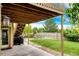 Backyard patio features a covered area, lush lawn, rock garden, and peaceful ambiance at 22962 Briar Leaf Ave, Parker, CO 80138