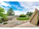 Landscaped backyard with lush lawn, charming rock garden, and inviting patio area at 22962 Briar Leaf Ave, Parker, CO 80138