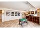 Basement featuring a foosball table, wet bar, tile flooring, and recessed lighting for a vibrant entertainment space at 22962 Briar Leaf Ave, Parker, CO 80138