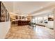 Finished basement boasting a wet bar with seating, tile flooring, and ample space for recreation and entertaining at 22962 Briar Leaf Ave, Parker, CO 80138