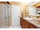 Bathroom featuring a glass enclosed shower, modern vanity with granite countertops, and neutral wall paint at 22962 Briar Leaf Ave, Parker, CO 80138