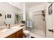 Bright bathroom featuring a glass-enclosed shower, neutral tile, and a modern vanity at 22962 Briar Leaf Ave, Parker, CO 80138