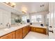 Bright bathroom with a double sink vanity, soaking tub, and a separate glass enclosed shower at 22962 Briar Leaf Ave, Parker, CO 80138