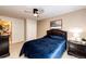 Bedroom featuring carpet, a ceiling fan, and an en-suite bathroom behind a closed door at 22962 Briar Leaf Ave, Parker, CO 80138