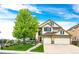 Charming two-story home features a three-car garage and inviting front porch at 22962 Briar Leaf Ave, Parker, CO 80138