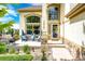 Inviting front porch featuring a seating area with comfortable chairs and a charming entryway at 22962 Briar Leaf Ave, Parker, CO 80138