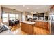 Open kitchen and eat-in area with stainless steel appliances and hardwood floors throughout main living area at 22962 Briar Leaf Ave, Parker, CO 80138