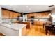 Spacious kitchen with stainless steel appliances, center island, hardwood floors, and adjacent dining area at 22962 Briar Leaf Ave, Parker, CO 80138
