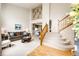 Open-concept living room with soaring ceilings and a grand staircase, creating an elegant and airy space at 22962 Briar Leaf Ave, Parker, CO 80138