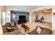 Cozy living room with plush seating, a large TV, a ceiling fan, and a bonus workout space at 22962 Briar Leaf Ave, Parker, CO 80138