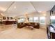 Open-concept living space featuring a wet bar, comfortable seating, a TV, and natural light from backyard views at 22962 Briar Leaf Ave, Parker, CO 80138