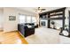 Cozy living room with a fireplace, custom built-ins, large windows, and a comfortable sectional sofa at 22962 Briar Leaf Ave, Parker, CO 80138