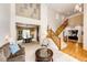 Inviting living room leading to dining area with a staircase, creating a seamless flow throughout the home at 22962 Briar Leaf Ave, Parker, CO 80138