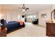 Spacious main bedroom with a vaulted ceiling, plush carpet, and large windows at 22962 Briar Leaf Ave, Parker, CO 80138
