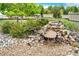Charming rock garden with a small waterfall feature and lush greenery at 22962 Briar Leaf Ave, Parker, CO 80138