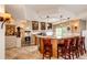 Basement wet bar with wooden stools, granite countertops, ambient lighting, and bonus popcorn maker at 22962 Briar Leaf Ave, Parker, CO 80138