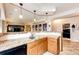 Basement kitchenette with sleek countertops, custom cabinets, and a convenient sink for easy entertaining at 22962 Briar Leaf Ave, Parker, CO 80138