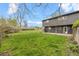 Expansive backyard featuring lush lawn and the home's exterior with access doors at 1000 Zang St, Golden, CO 80401