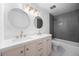 Modern bathroom with double sinks, stylish vanity, and tiled shower at 1000 Zang St, Golden, CO 80401