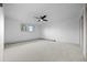 Minimalist bedroom with ceiling fan, large window, and neutral carpet at 1000 Zang St, Golden, CO 80401