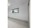 Bright bedroom with large window, neutral carpet, and baseboard radiator at 1000 Zang St, Golden, CO 80401