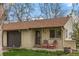 Close-up of brick facade with comfy chairs on the porch, a charming welcome to the home at 1000 Zang St, Golden, CO 80401