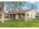 Charming single-story home with a well-manicured lawn, brick accents, and cozy front porch at 1000 Zang St, Golden, CO 80401