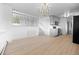 Spacious living room with modern chandelier, hardwood floors, and staircase to upper level at 1000 Zang St, Golden, CO 80401