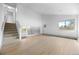 Bright, open living room with wood floors and staircase, a modern living space at 1000 Zang St, Golden, CO 80401