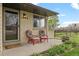 Inviting brick porch featuring cozy seating and well-kept landscaping at 1000 Zang St, Golden, CO 80401